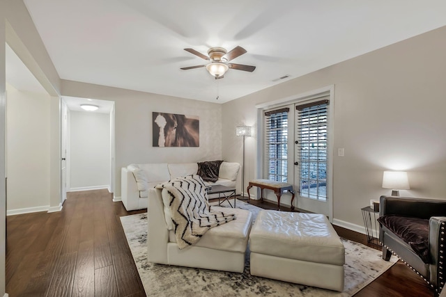 living room featuring dark hardwood / wood-style floors and ceiling fan