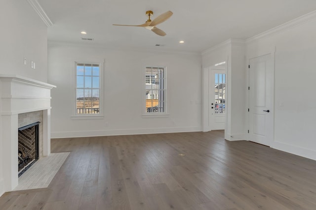 unfurnished living room with recessed lighting, ornamental molding, a fireplace with flush hearth, baseboards, and hardwood / wood-style flooring