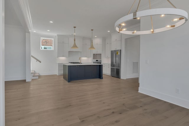 kitchen with light countertops, high quality fridge, visible vents, and white cabinets