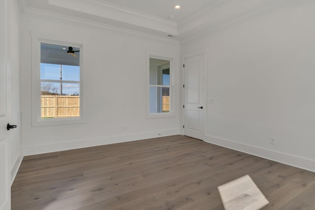 unfurnished room featuring ornamental molding, baseboards, and wood finished floors