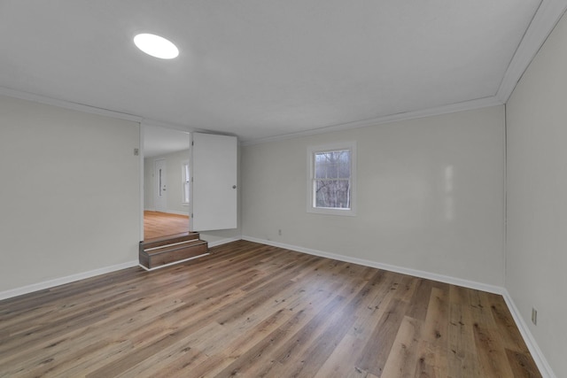 unfurnished room with ornamental molding and light hardwood / wood-style flooring