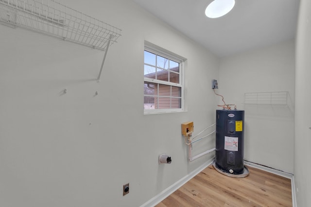 clothes washing area with electric water heater, wood-type flooring, and hookup for an electric dryer