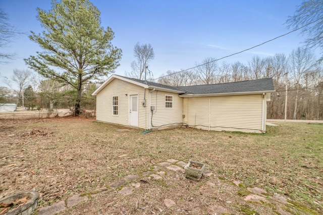 back of house with a lawn