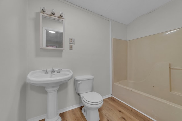 bathroom with hardwood / wood-style flooring and toilet