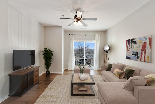 living room featuring ceiling fan and dark hardwood / wood-style flooring