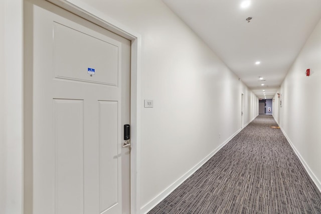 corridor with dark colored carpet