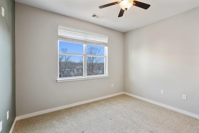 carpeted spare room featuring ceiling fan