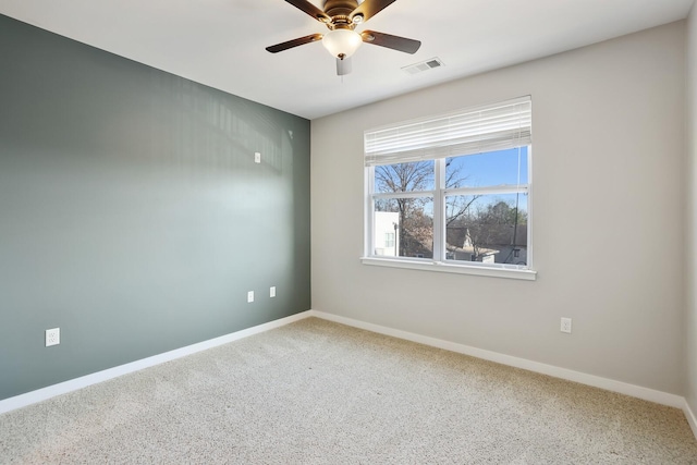 carpeted spare room featuring ceiling fan