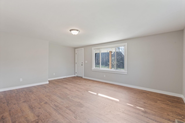 spare room with light hardwood / wood-style flooring