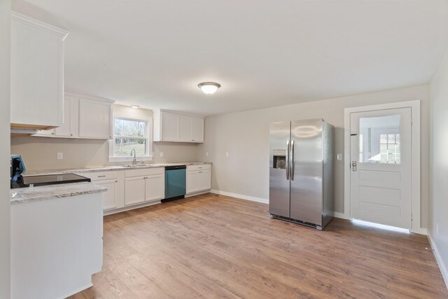 kitchen with white cabinetry, sink, appliances with stainless steel finishes, and light hardwood / wood-style flooring