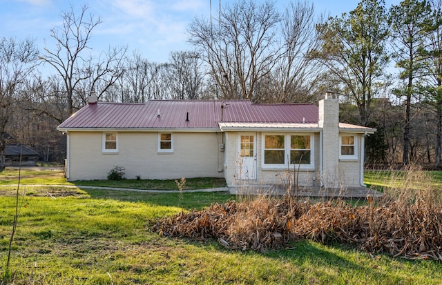 rear view of property featuring a yard