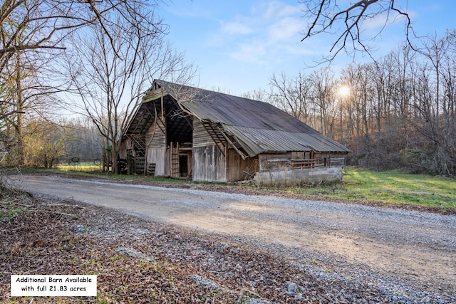 view of home's exterior with an outbuilding