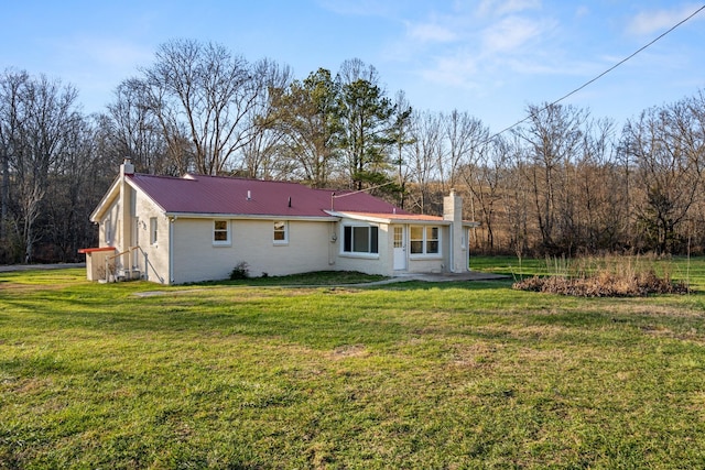 rear view of property with a lawn