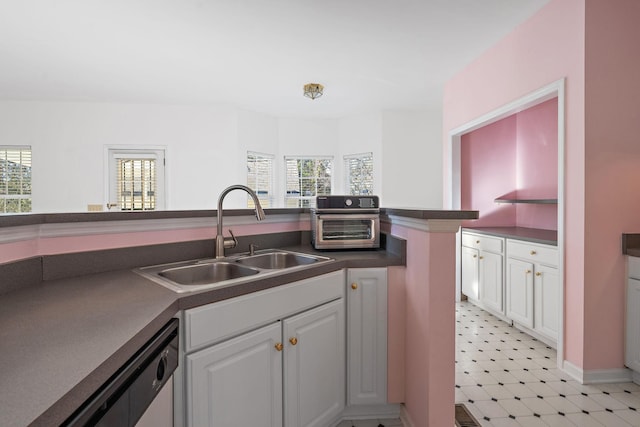 kitchen with a wealth of natural light, sink, and white cabinets