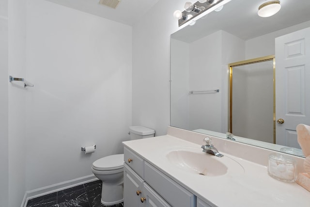 bathroom with vanity, toilet, and a shower with shower door