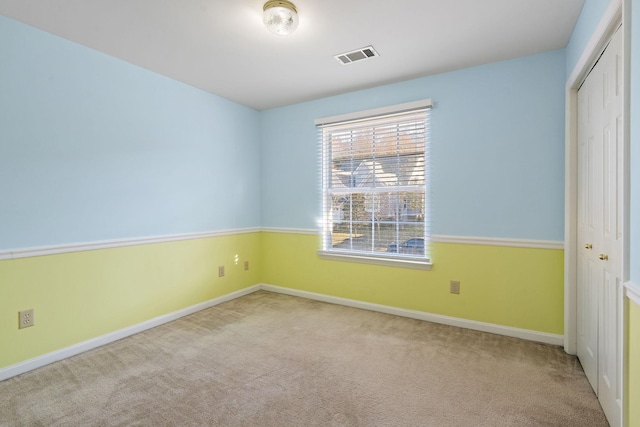 unfurnished room with light colored carpet