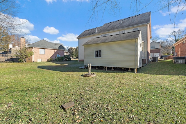 back of property featuring a yard