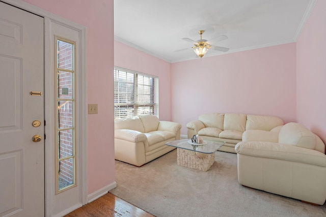 living room with ceiling fan, wood-type flooring, and ornamental molding