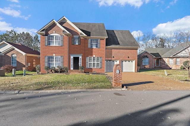 view of front of property featuring a garage and a front lawn