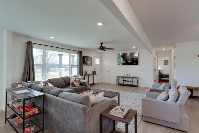 living room with light hardwood / wood-style floors and ceiling fan