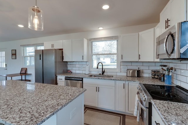 kitchen featuring white cabinetry, sink, and appliances with stainless steel finishes