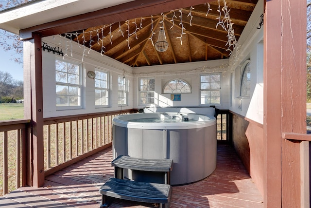 sunroom / solarium with a jacuzzi, vaulted ceiling, and a wealth of natural light