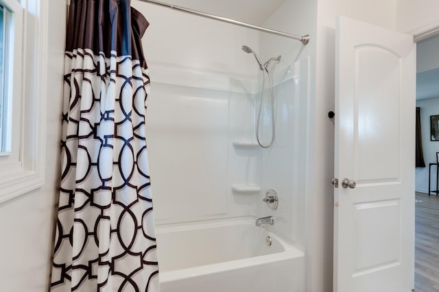 bathroom featuring hardwood / wood-style floors and shower / tub combo