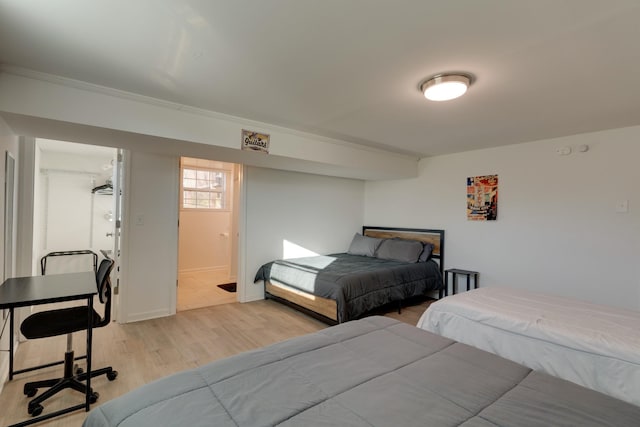 bedroom with light hardwood / wood-style flooring and ornamental molding