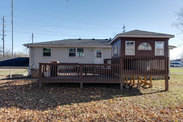 back of property featuring a yard and a wooden deck