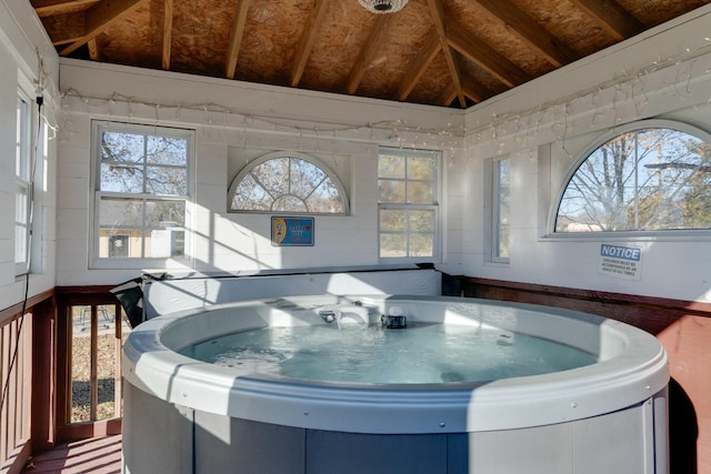 interior space featuring vaulted ceiling and a hot tub