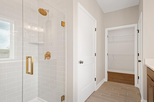 bathroom with vanity and a shower with shower door