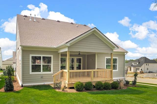 rear view of property with a lawn and a porch