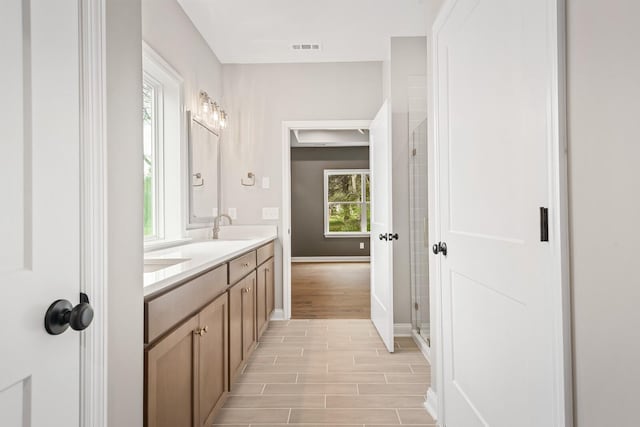 bathroom featuring a shower and vanity