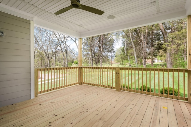 wooden deck featuring a yard and ceiling fan