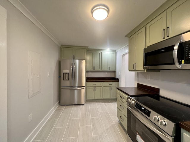 kitchen with electric panel, ornamental molding, green cabinetry, and appliances with stainless steel finishes