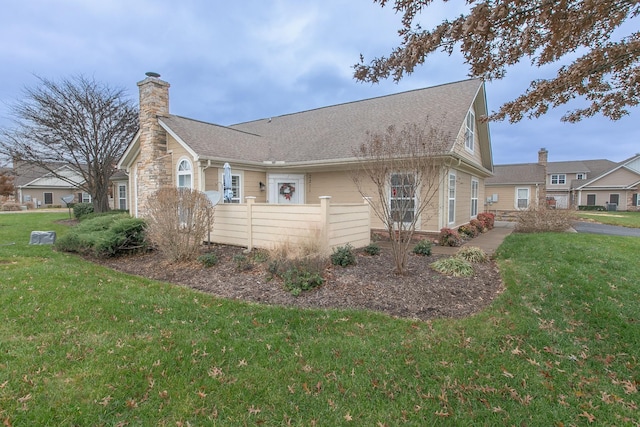 view of side of property with a lawn