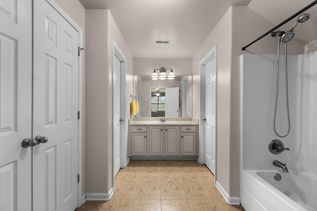 bathroom with ceiling fan, vanity, tub / shower combination, and tile patterned floors