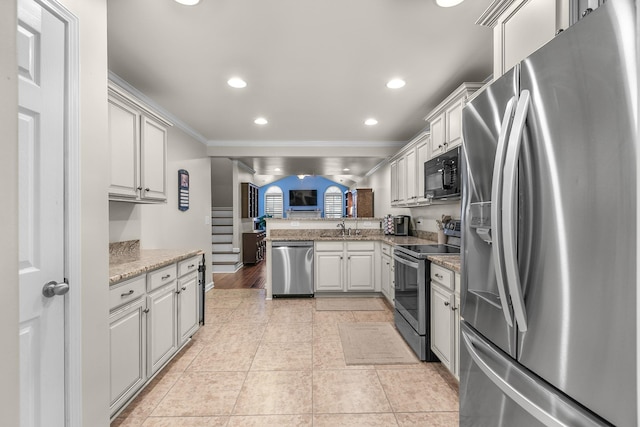 kitchen with sink, crown molding, light stone counters, kitchen peninsula, and stainless steel appliances