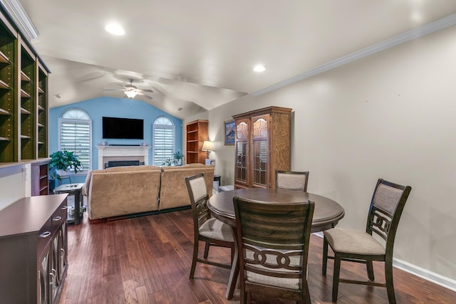 dining space featuring dark hardwood / wood-style flooring, lofted ceiling, crown molding, and ceiling fan