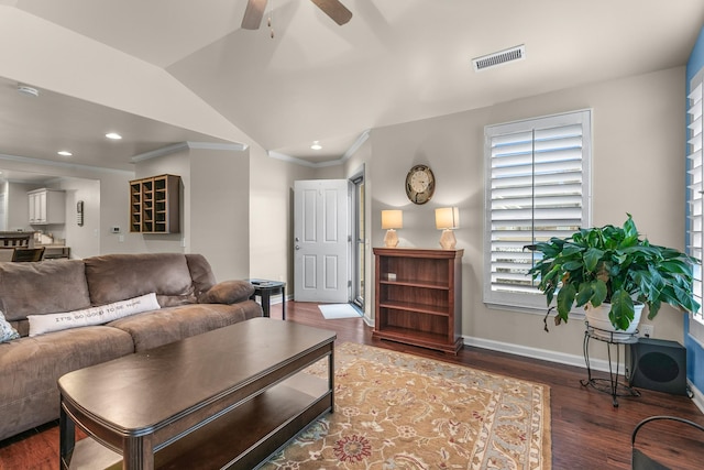 living room with ceiling fan, ornamental molding, dark hardwood / wood-style flooring, and vaulted ceiling