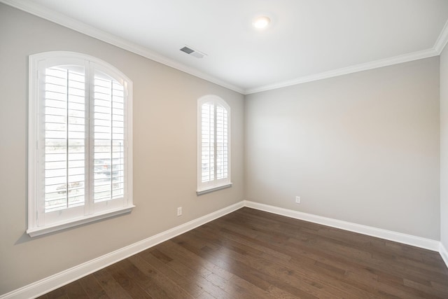 empty room with ornamental molding and dark wood-type flooring