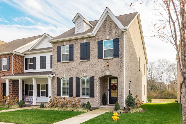 view of front of home featuring a front yard and a porch