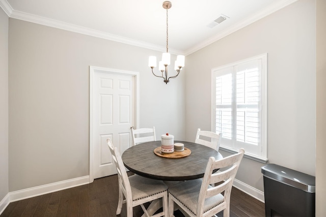 dining space with dark hardwood / wood-style flooring, ornamental molding, and an inviting chandelier