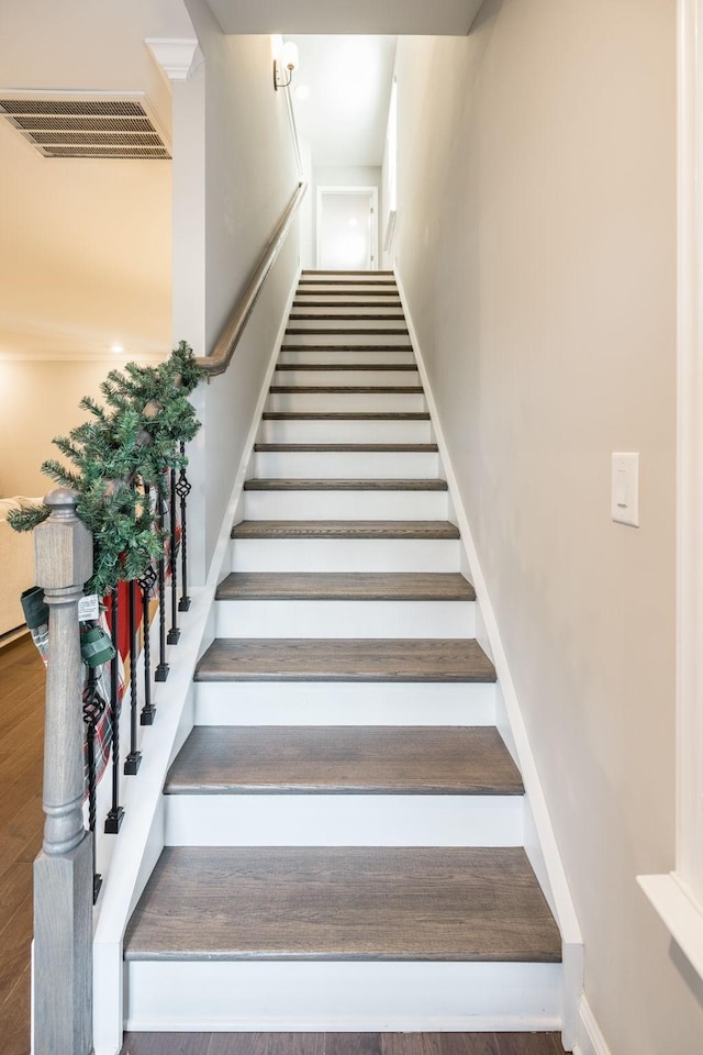 stairway with hardwood / wood-style floors