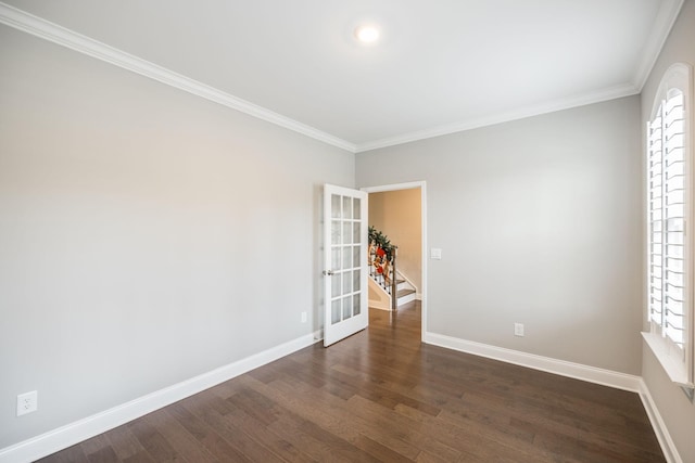 unfurnished room with plenty of natural light, dark hardwood / wood-style flooring, ornamental molding, and french doors