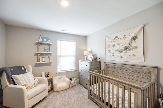 carpeted bedroom with a crib