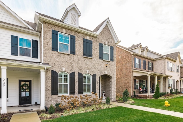 view of property featuring a front lawn