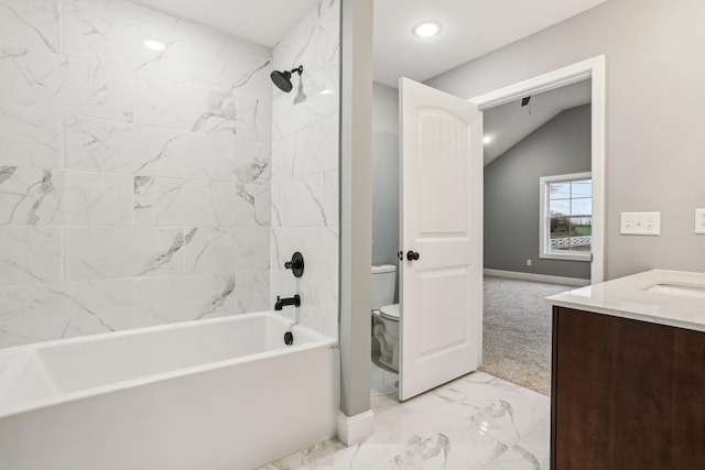 full bathroom with vanity, tiled shower / bath, vaulted ceiling, and toilet