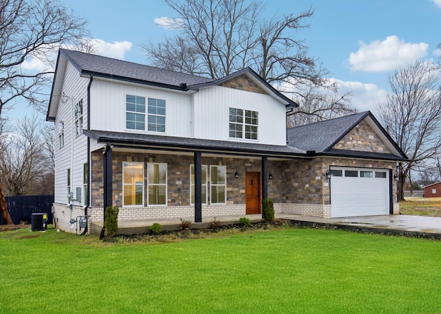 view of front of property featuring central AC, a front yard, and a garage