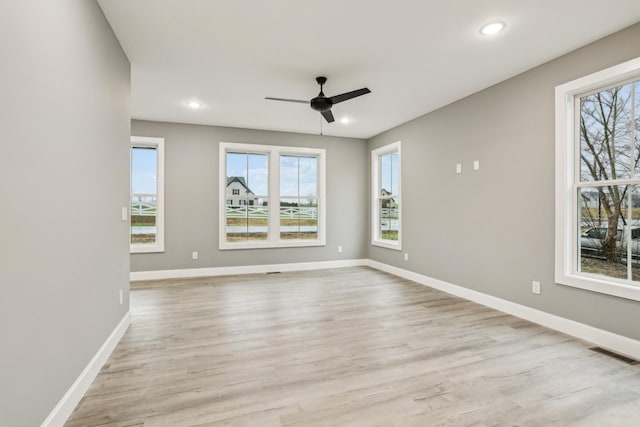 spare room featuring light hardwood / wood-style flooring and ceiling fan